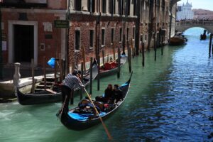 Classic Venice scene with gondolas navigating a historic canal, capturing Venetian charm.